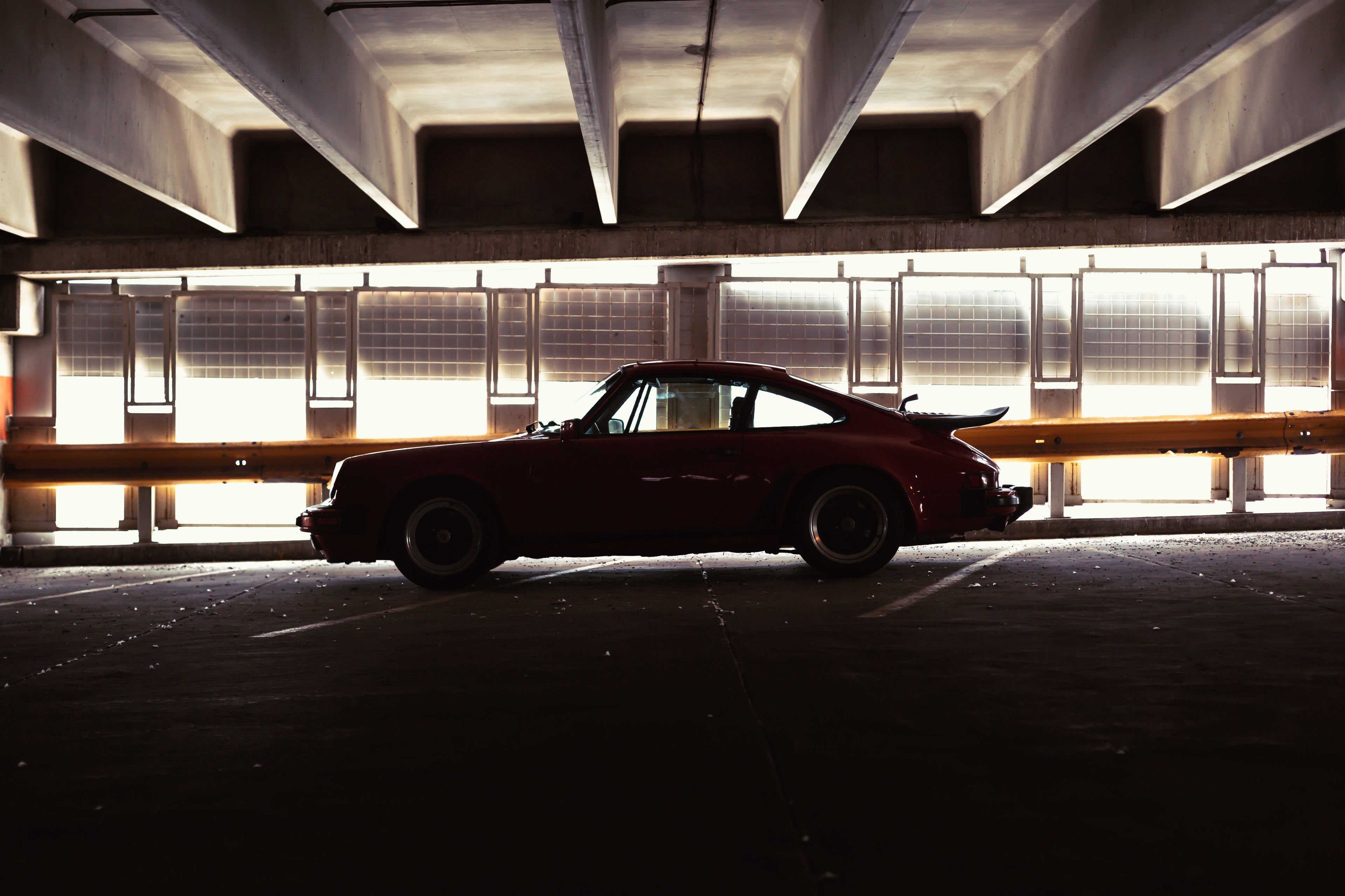 Moody garage shot of a Porsche 911 silhouette – blending art, shadow, and automotive heritage.